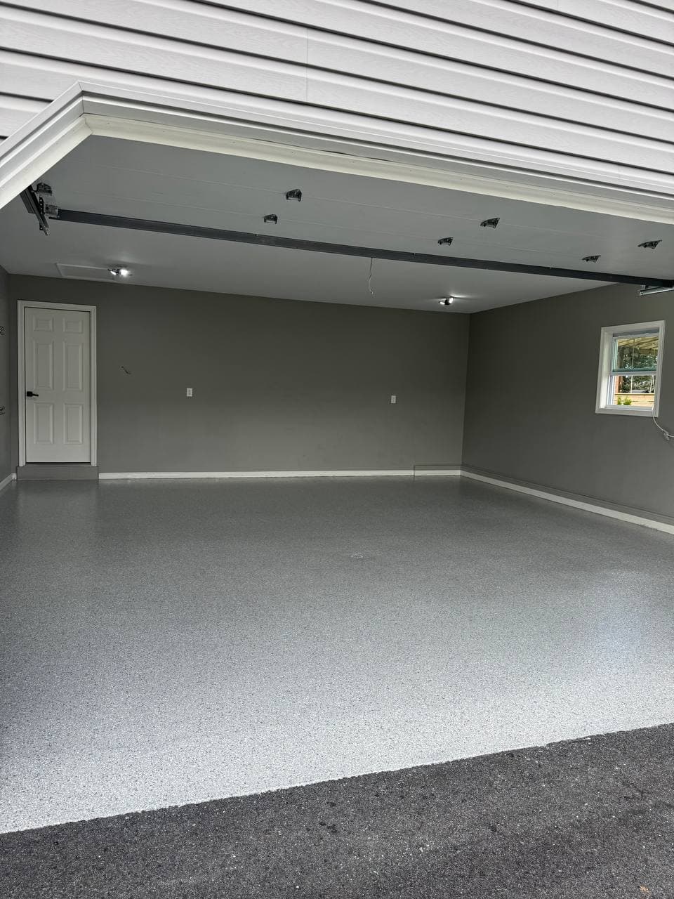 A newly coated garage floor seen from the driveway