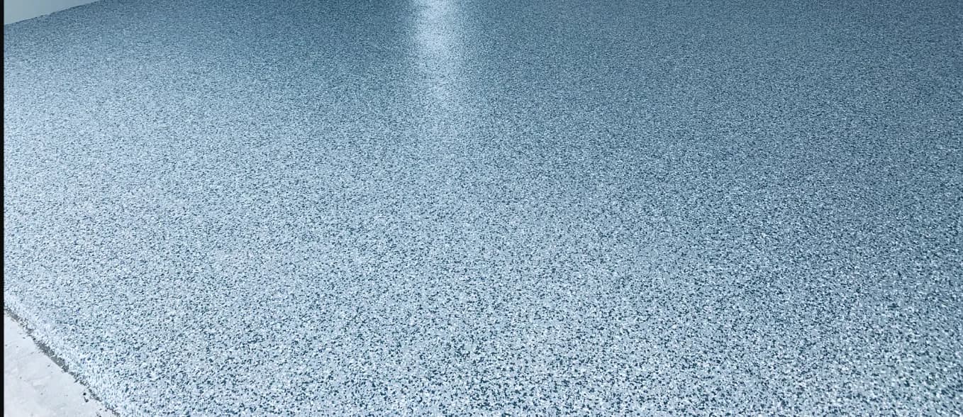 A polyaspartic flake floor several seasons into service