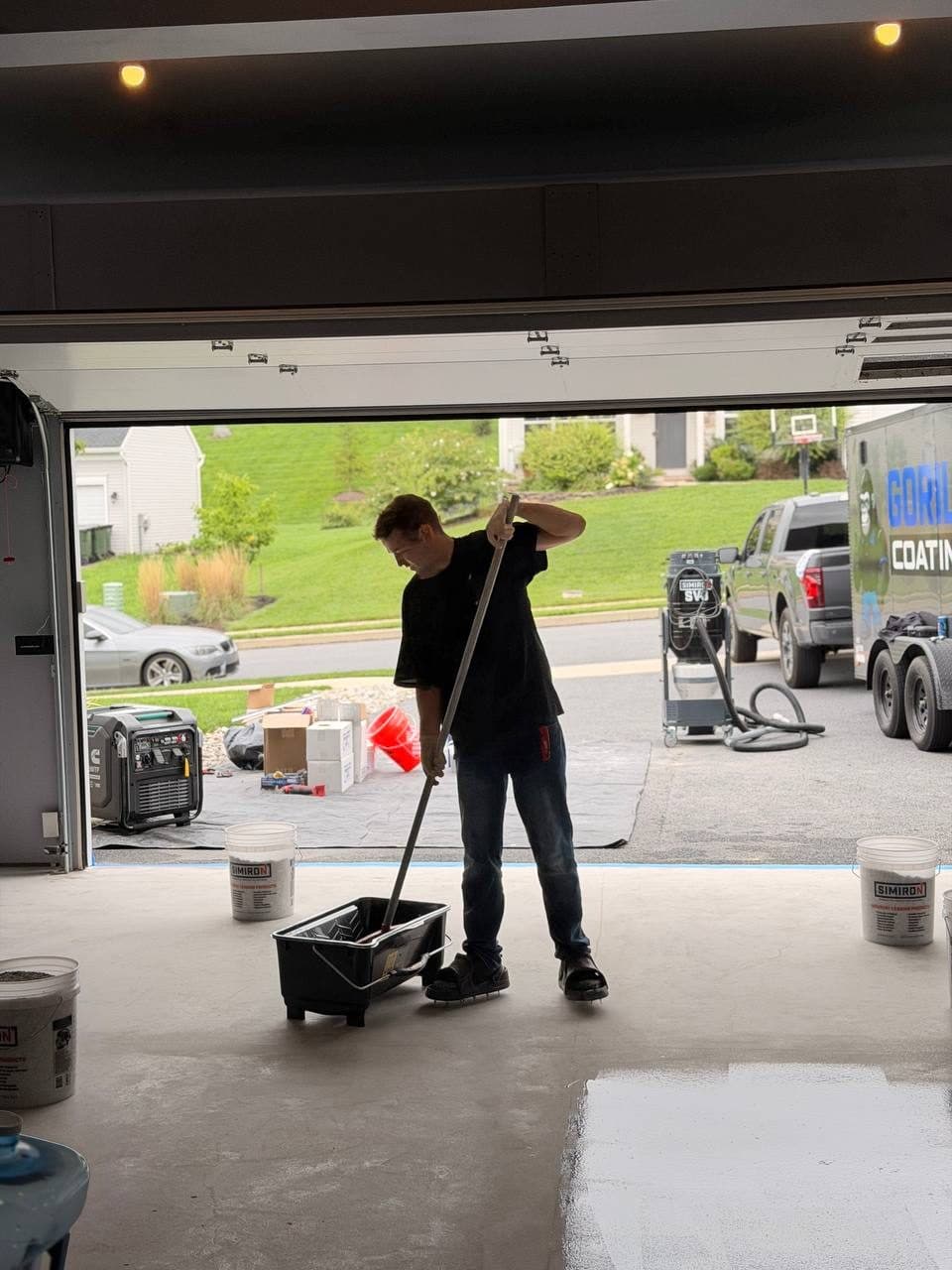 Crew squeegeeing topcoat with the truck visible through the open door